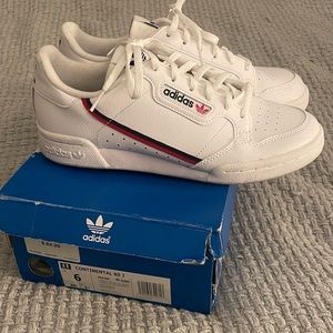 Adidas white sneakers .